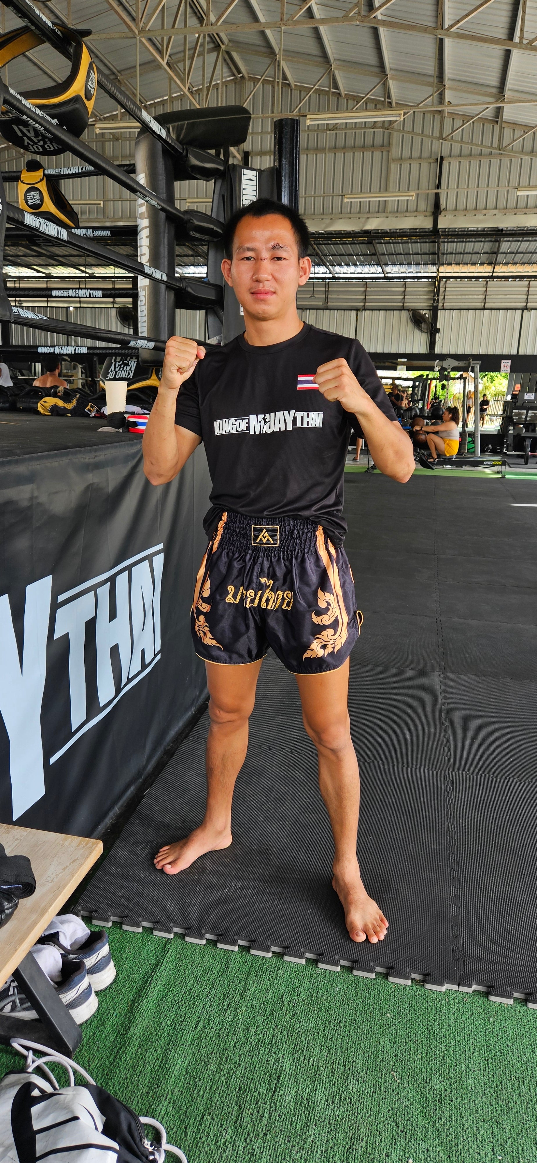 Black Gold Muay Thai shorts – fighter in intense training action shot – order premium competition fight shorts Thailand
