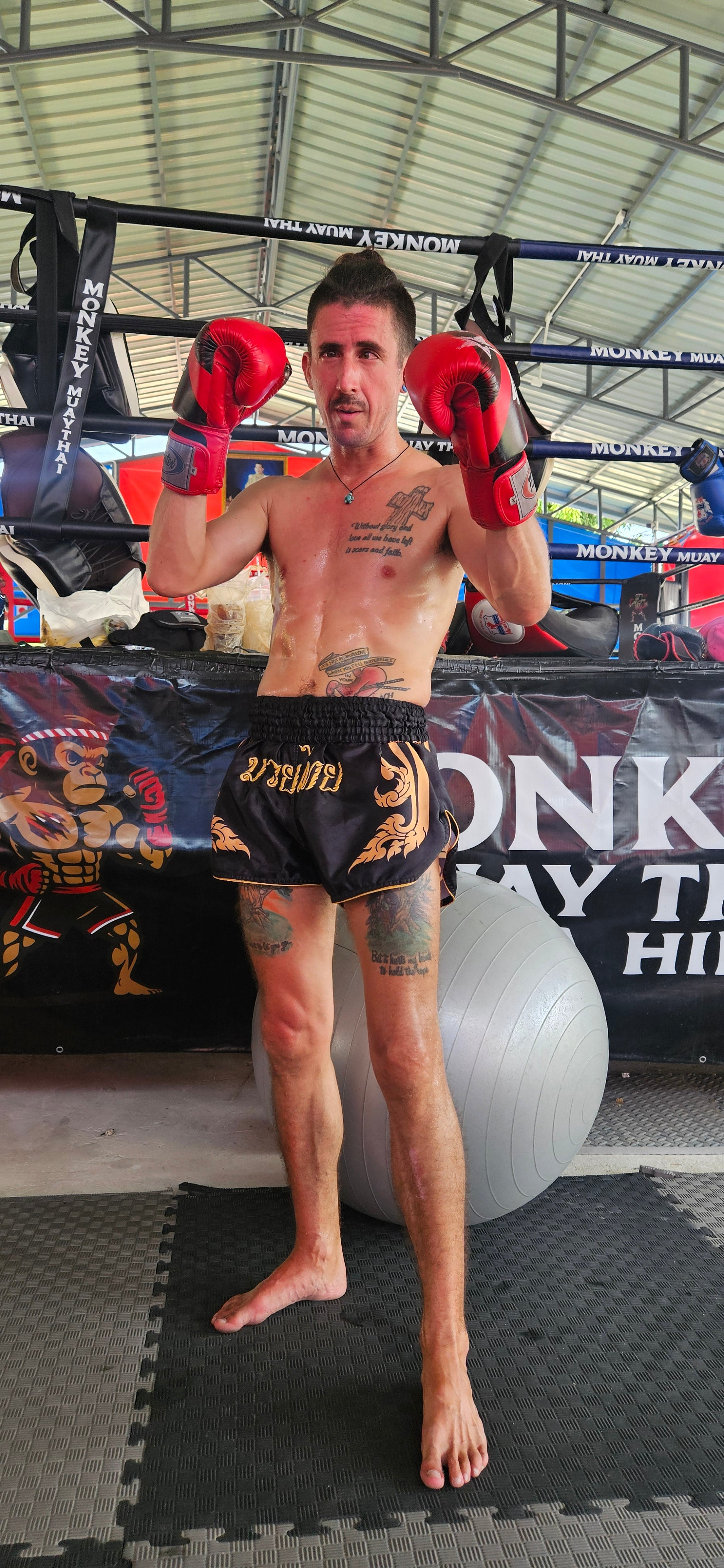 Black Gold Muay Thai shorts side view – lightweight premium satin fabric – shop elite fight shorts Thailand
