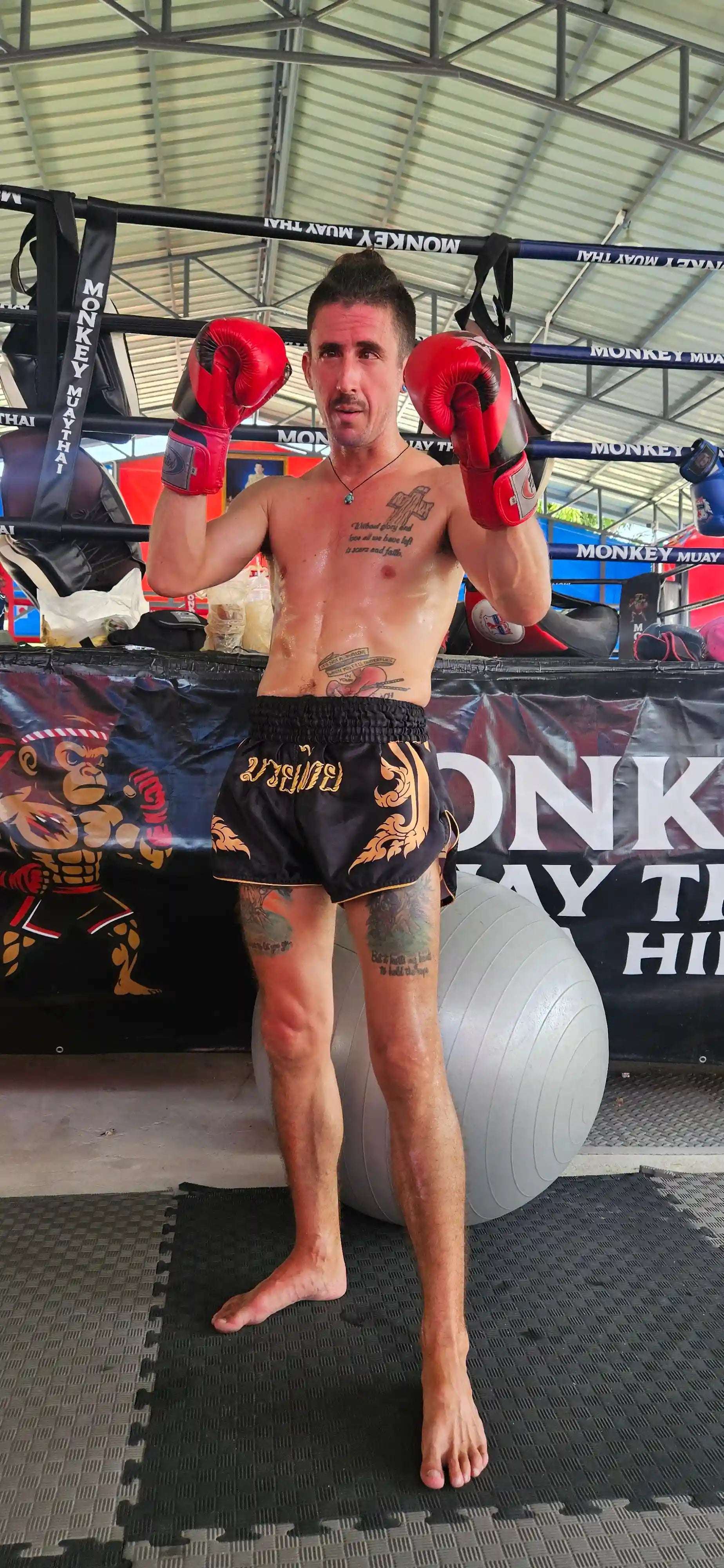 Black Gold Muay Thai shorts side view – lightweight premium satin fabric – shop elite fight shorts Thailand
