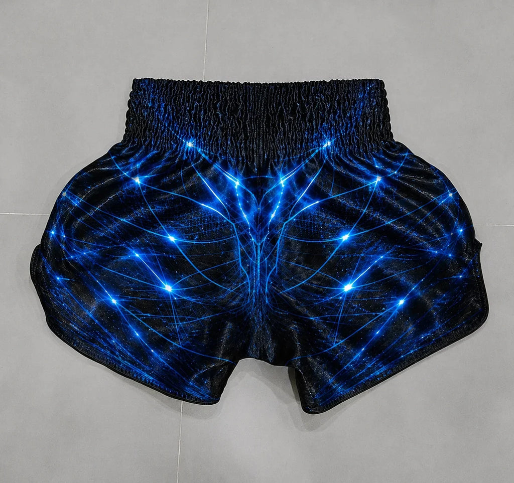Blue Voltage Muay Thai shorts – fighter in explosive training action shot – shop elite blue fight wear Thailand
