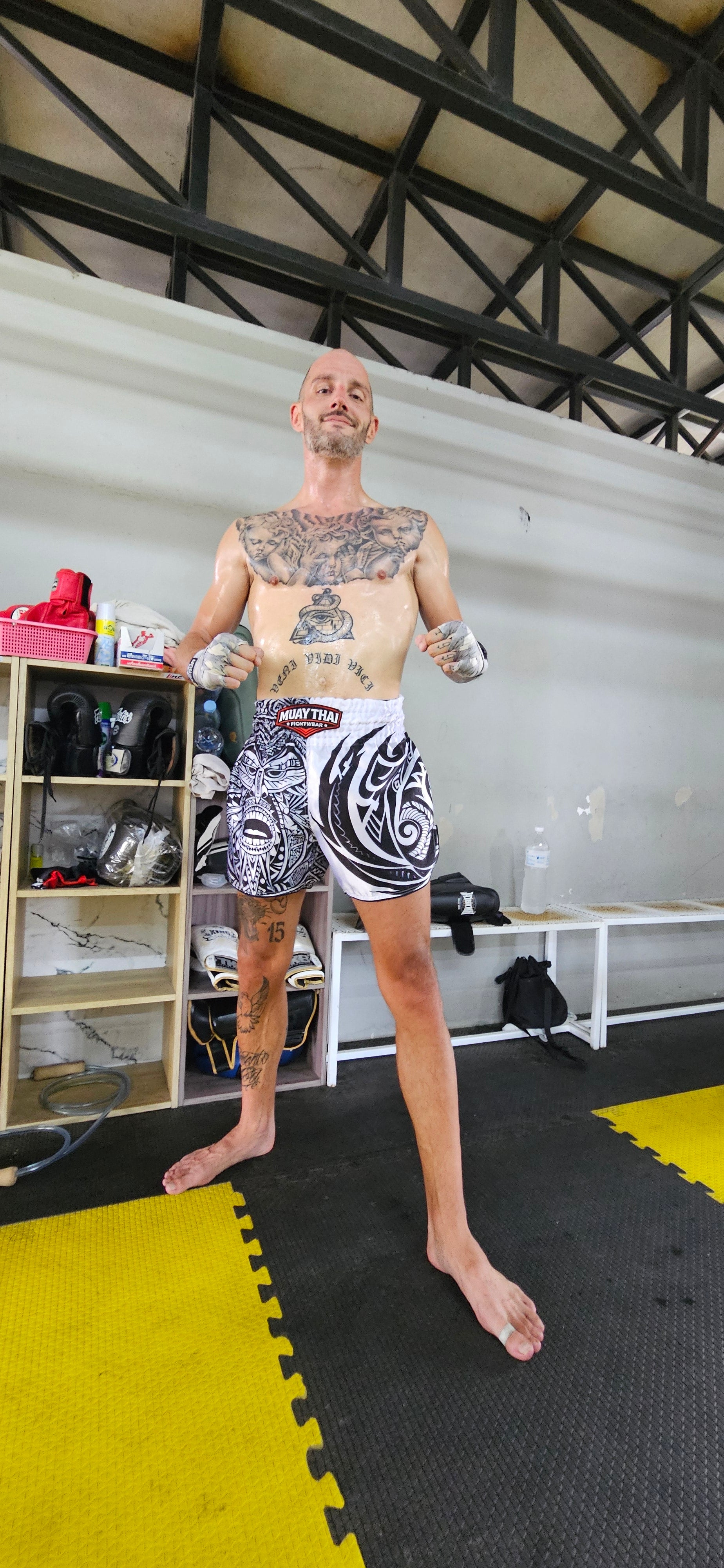 Maori Reign Muay Thai shorts – fighter in powerful side stance action shot – order premium tribal fight shorts Thailand
