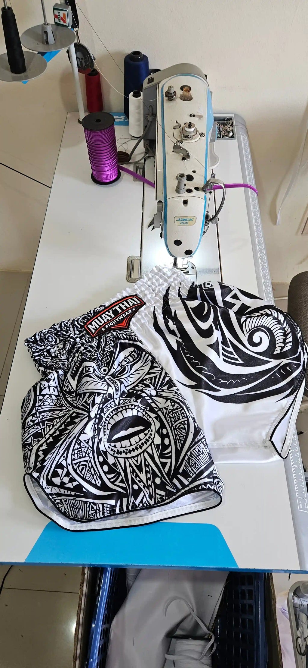 Maori Reign Muay Thai shorts – fighter delivering explosive knee strike – order premium tribal Muay Thai gear Thailand
