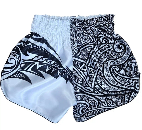Maori Reign Muay Thai shorts – intricate Maori tattoo design detail on premium satin – shop authentic fight wear Thailand
