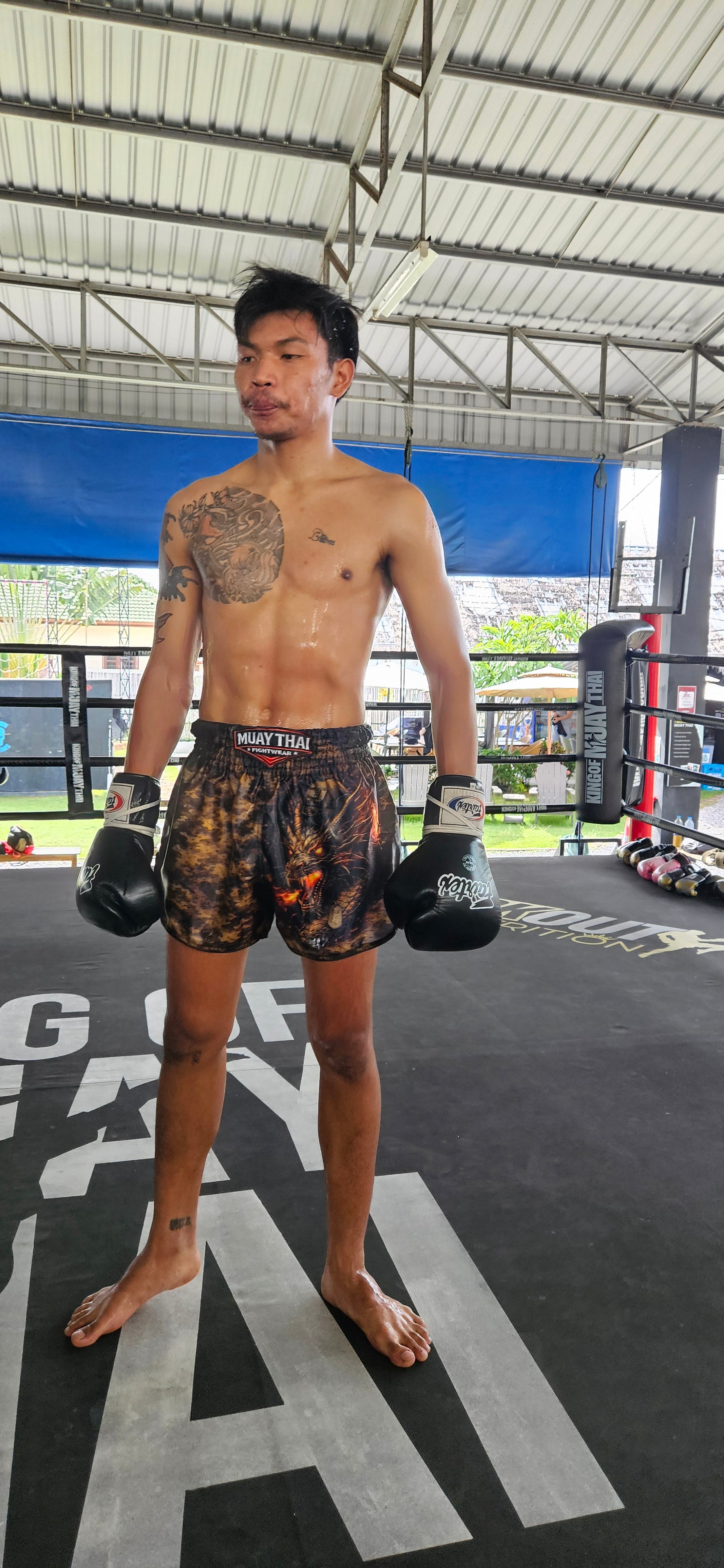 Military Muay Thai shorts – fighter in dynamic side action shot – order premium fight shorts Thailand
