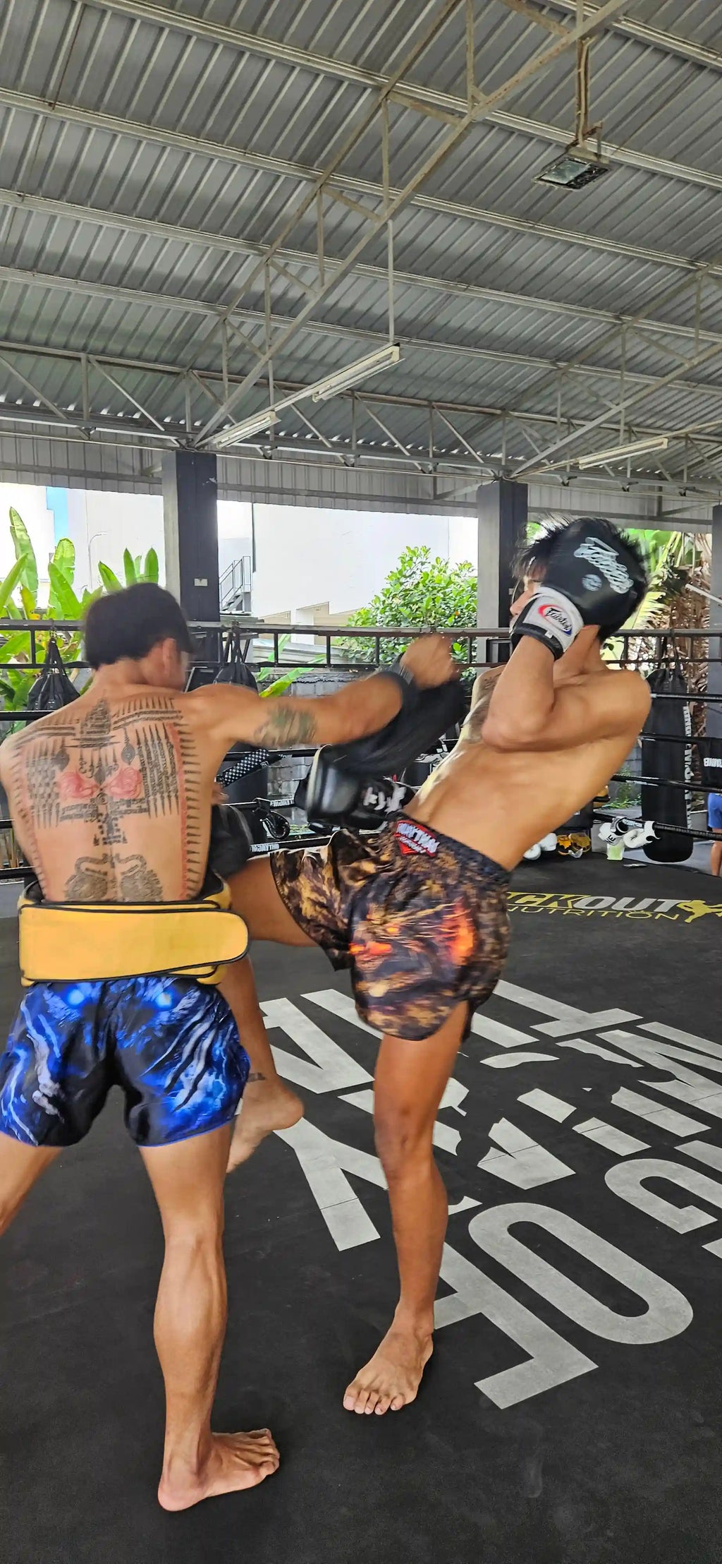Military Muay Thai shorts – full body fighter stance in premium tactical shorts – shop fight wear Thailand now
