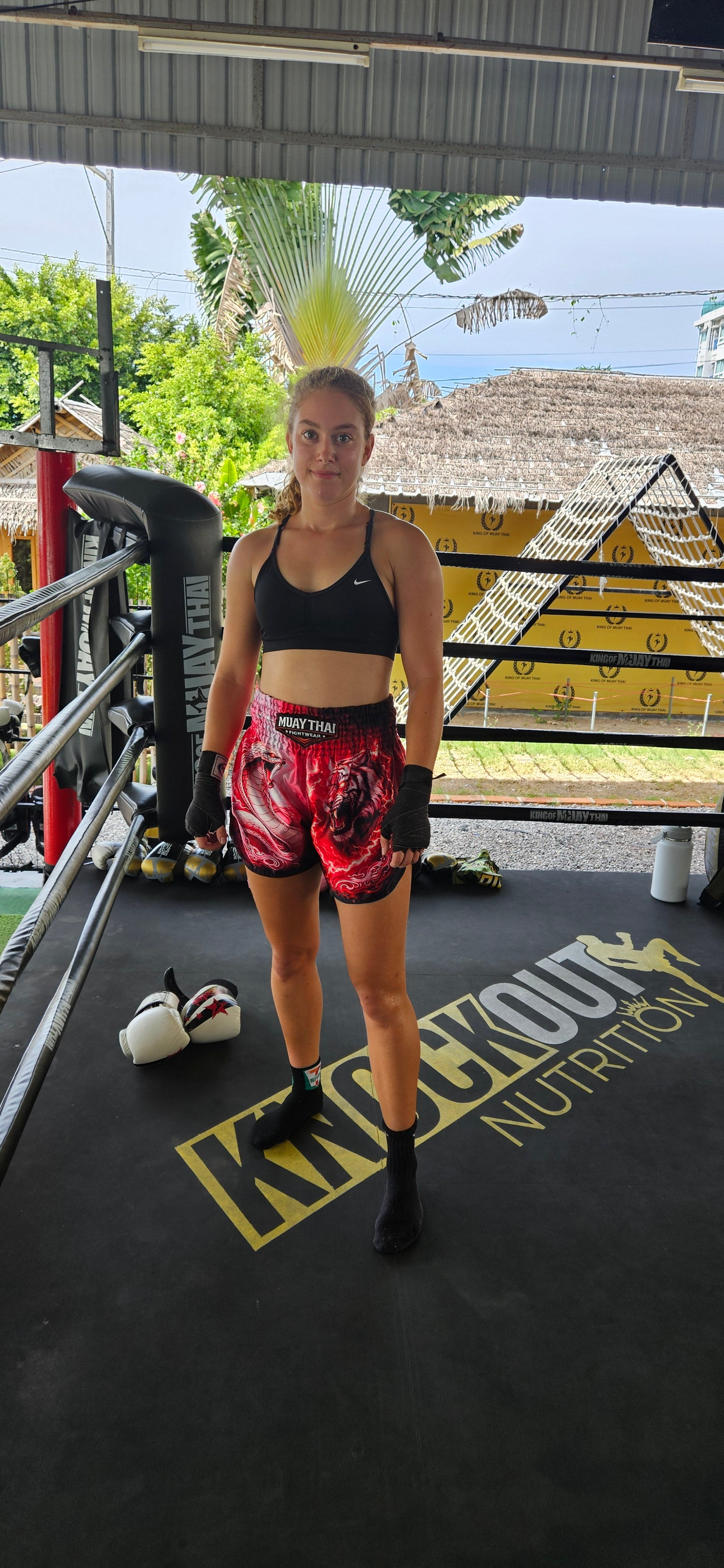 Snake Tiger Muay Thai shorts – fighter executing powerful side kick – order elite animal print fight shorts Thailand
