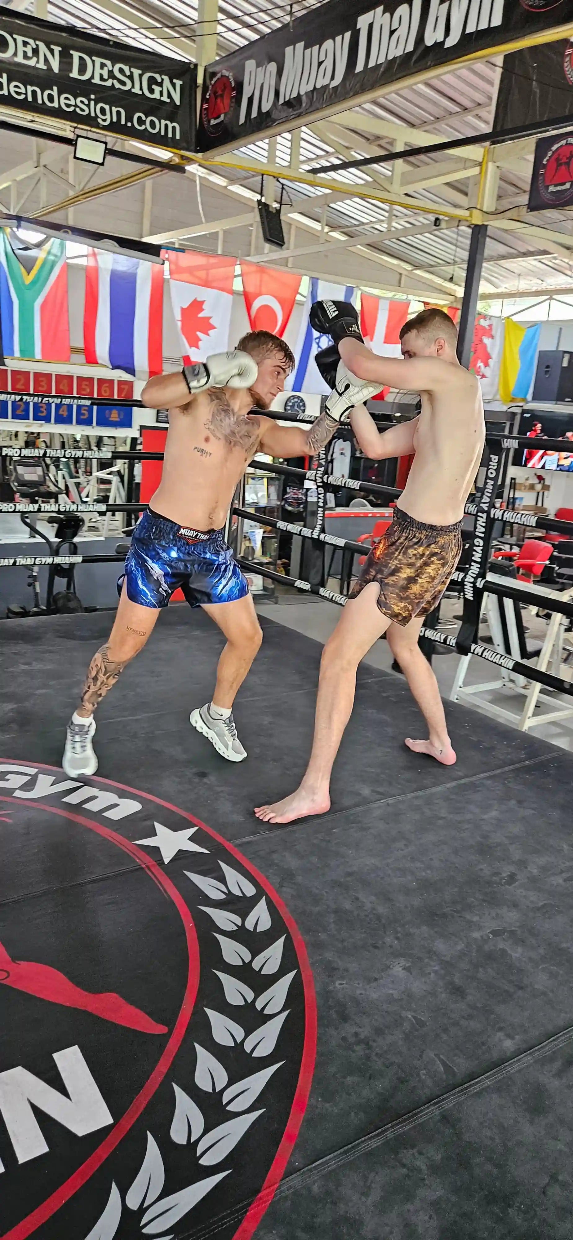 Storm Beast Muay Thai shorts – fighter full body action shot in dark premium shorts – shop fight wear Thailand
